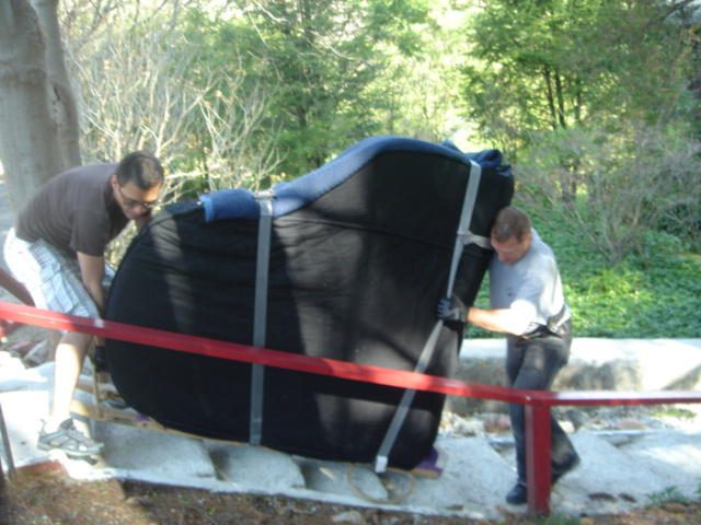 piano land team working on moving a piano - new york piano movers